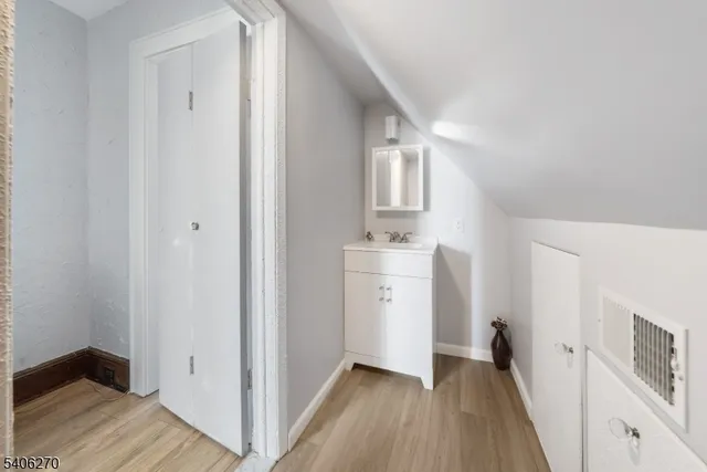 a kitchen with stainless steel appliances granite countertop a sink a stove a refrigerator cabinets and a dining table