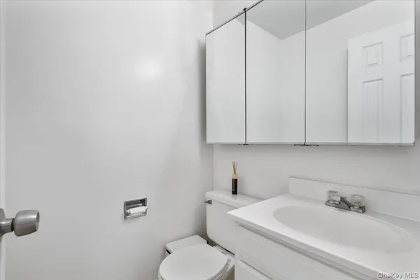a bathroom with a toilet sink and mirror