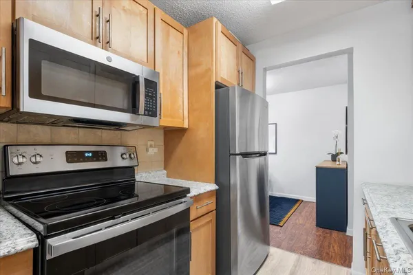a kitchen with a stove microwave and refrigerator