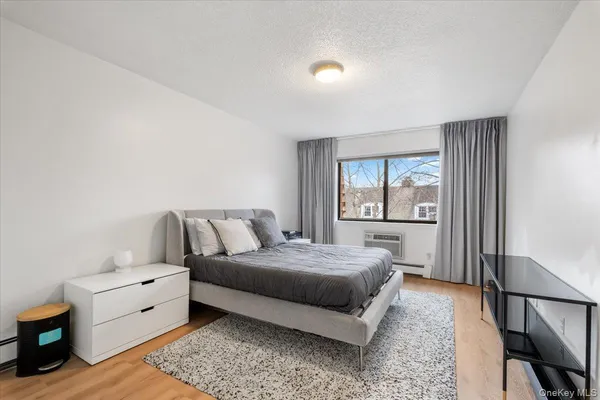 a spacious bedroom with a bed and a window