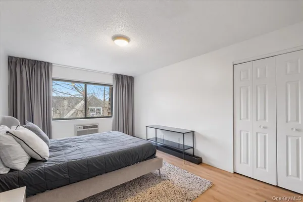 a bedroom with a large bed and a window