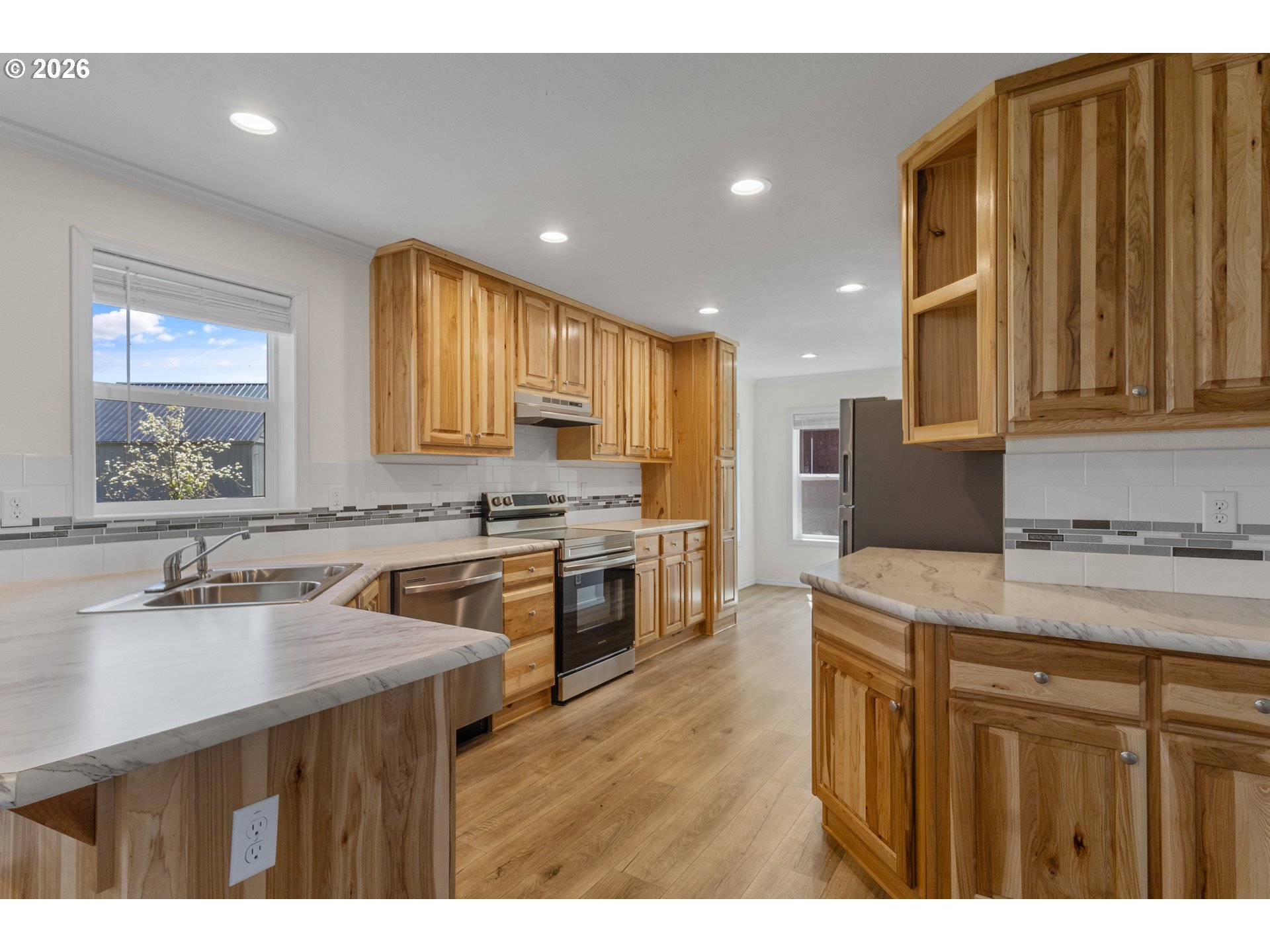 365 Mountain View Road Sweet Home, OR 97386 - Photo 11 of 32 a kitchen with stainless steel appliances a sink stove and cabinets