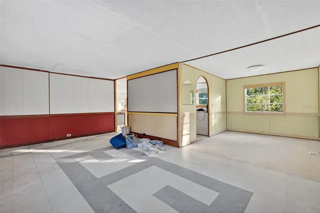 a view of an empty room with painting on the wall