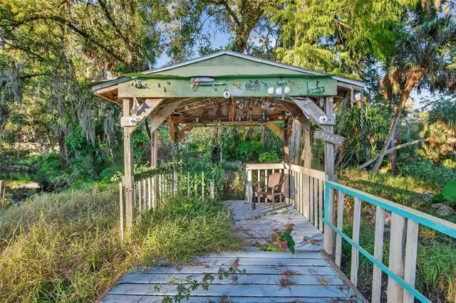 a view of balcony with wooden deck and outdoor seating