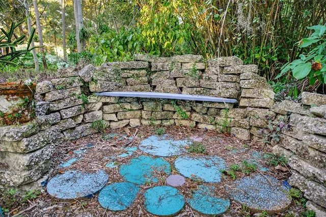 a view of a yard with plants and outdoor seating