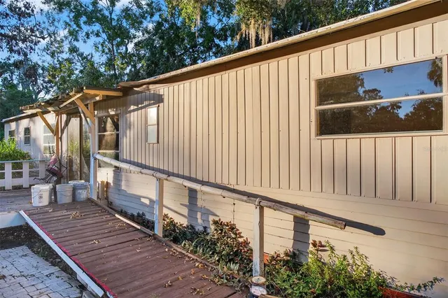 a balcony view with wooden floor and outdoor seating