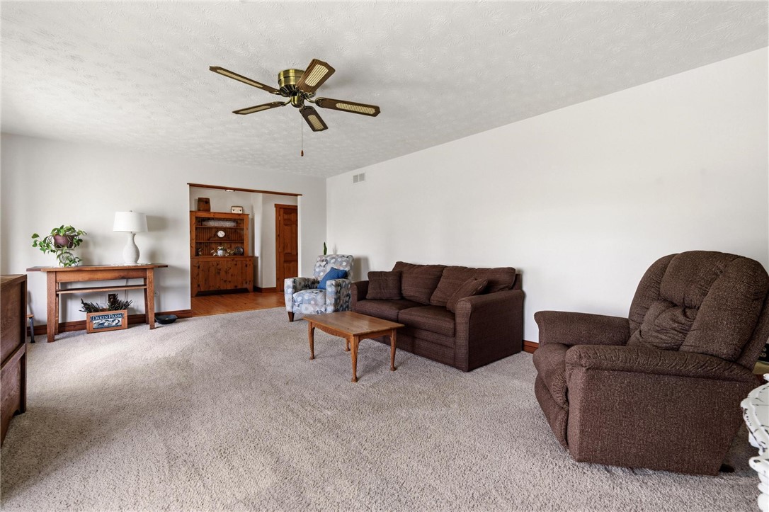 4971 Lackey Road Cedarville, OH 45314 - Photo 18 of 79 This inviting living room offers comfortable carpeted floors and a cooling ceiling fan.