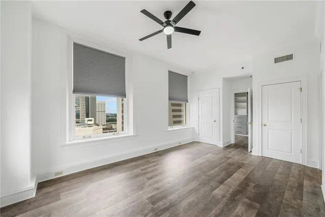 a view of a room with wooden floor and white walls