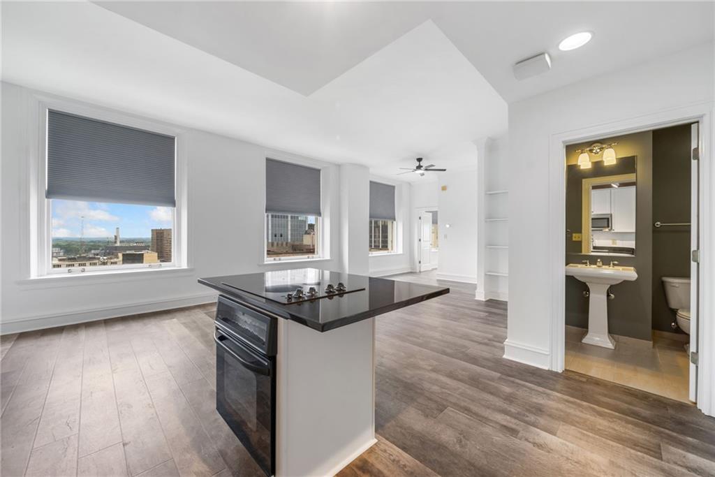 57 Forsyth Street Northwest, Unit 16G Atlanta, GA 30303 - Photo 22 of 32 a living room with furniture and a wooden floor
