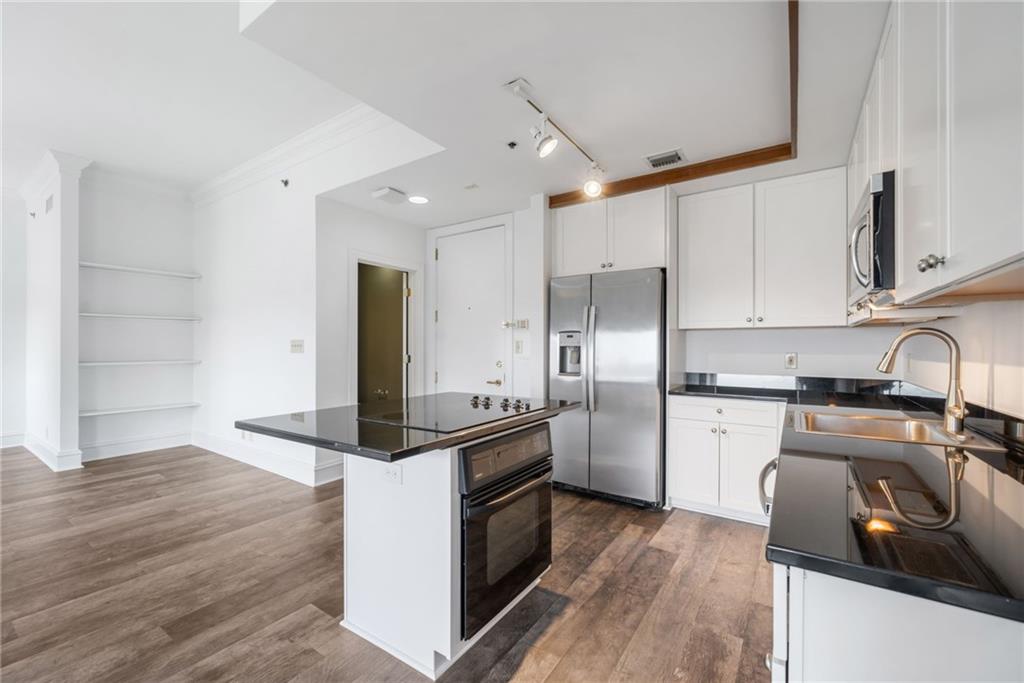 57 Forsyth Street Northwest, Unit 16G Atlanta, GA 30303 - Photo 23 of 32 a kitchen with a sink stove and refrigerator