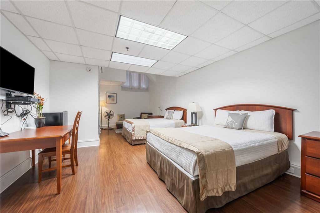 57 Forsyth Street Northwest, Unit 16G Atlanta, GA 30303 - Photo 29 of 32 a bedroom with two beds and a chair