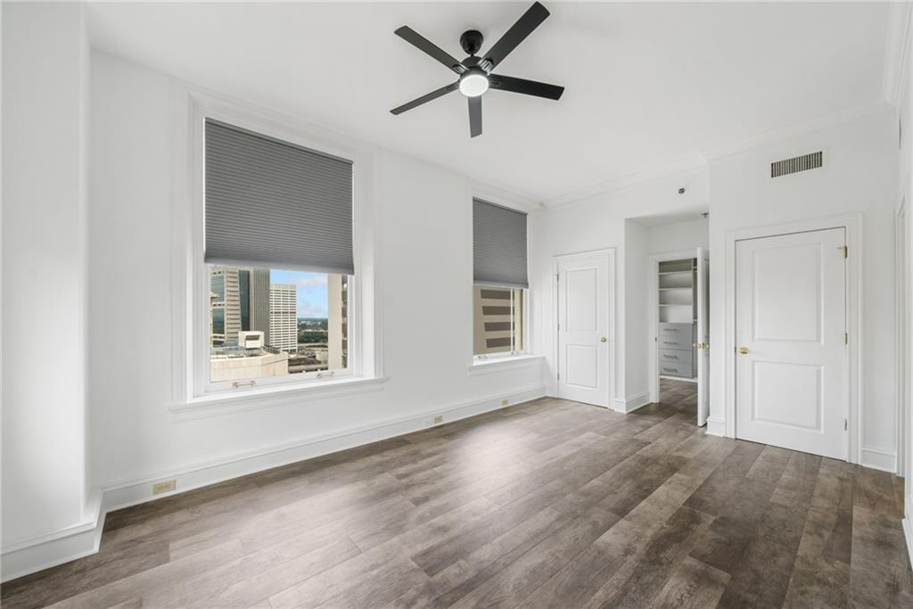 57 Forsyth Street Northwest, Unit 16G Atlanta, GA 30303 - Photo 7 of 27 a view of an empty room with a window and wooden floor