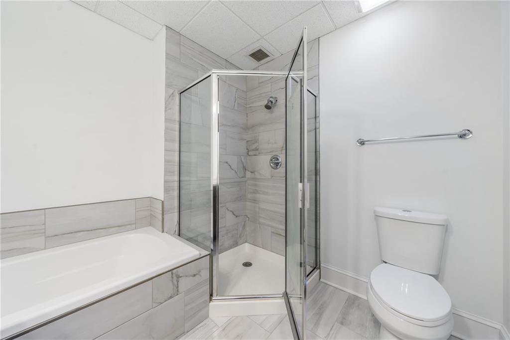 57 Forsyth Street Northwest, Unit 16G Atlanta, GA 30303 - Photo 10 of 27 a bathroom with a shower a toilet and a sink