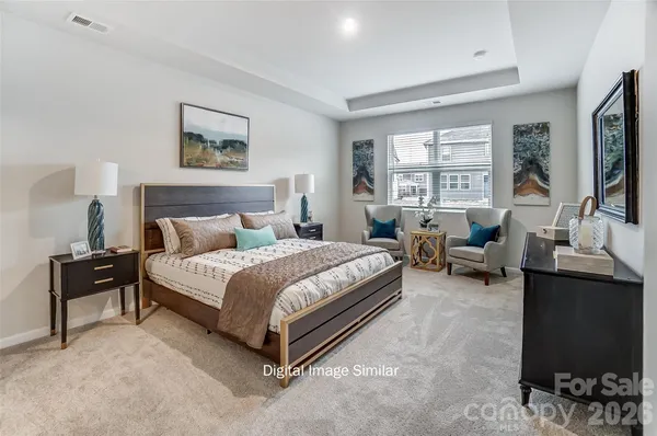 a spacious bedroom with a bed and a couch