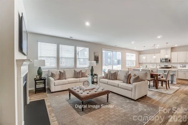 a living room with fireplace furniture and a large window
