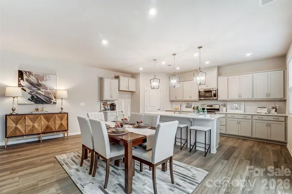 a view of kitchen with cabinets table and chairs