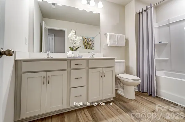 a spacious bathroom with a sink a toilet and shower
