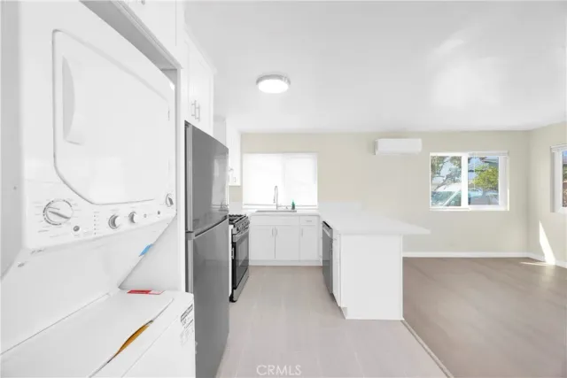 wooden floor & utility room with a window