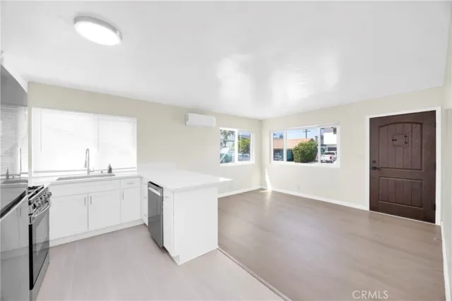 a view of a kitchen with a sink cabinets and wooden floor