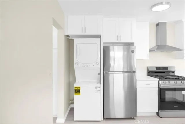a white refrigerator freezer and a stove sitting inside of a kitchen