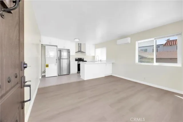 a view of a kitchen with a sink and a refrigerator