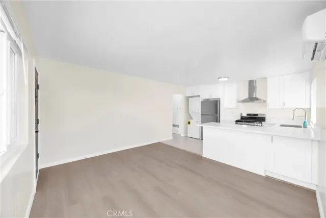 a large white kitchen with cabinets