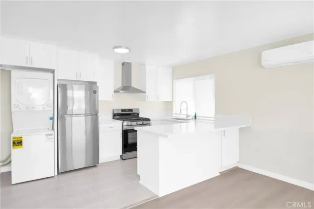 a kitchen with stainless steel appliances a refrigerator sink and stove