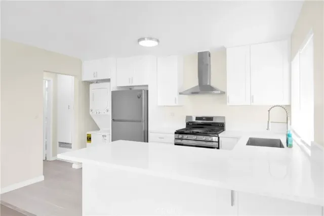 a kitchen with stainless steel appliances a stove and a refrigerator
