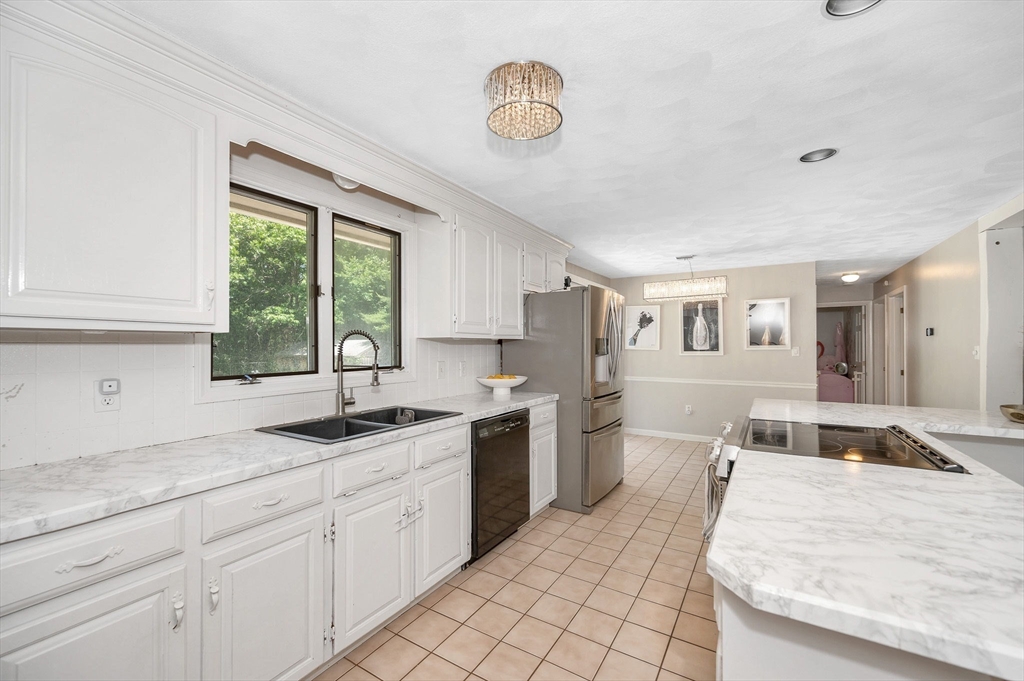 5 Silverbirch Road Billerica, MA 01821 - Photo 3 of 36 a kitchen with stainless steel appliances granite countertop a sink stove and cabinets