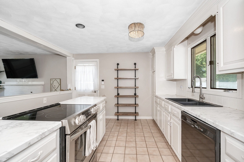 5 Silverbirch Road Billerica, MA 01821 - Photo 4 of 36 a kitchen with a sink and a stove top oven with wooden floor