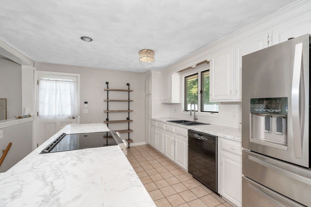 5 Silverbirch Road Billerica, MA 01821 - Photo 6 of 36 a kitchen with granite countertop a sink stove and refrigerator