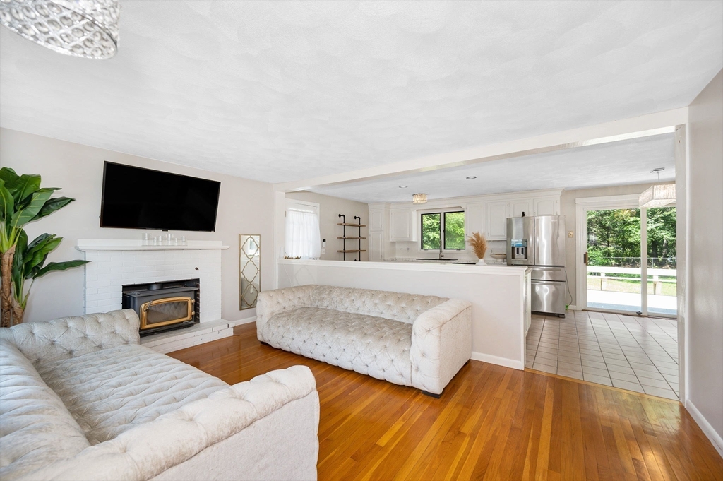 5 Silverbirch Road Billerica, MA 01821 - Photo 10 of 36 a living room with furniture a fireplace and a flat screen tv
