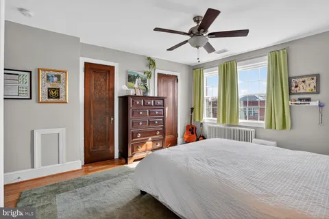 a bedroom with a large bed and a large window