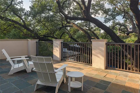 a view of a chair and table in the back yard of the house