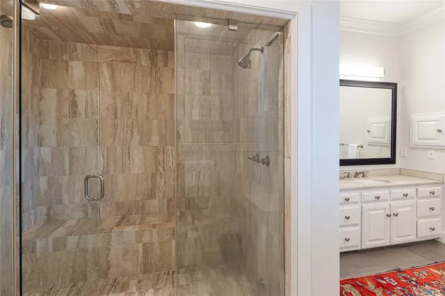 a bathroom with a shower and a sink