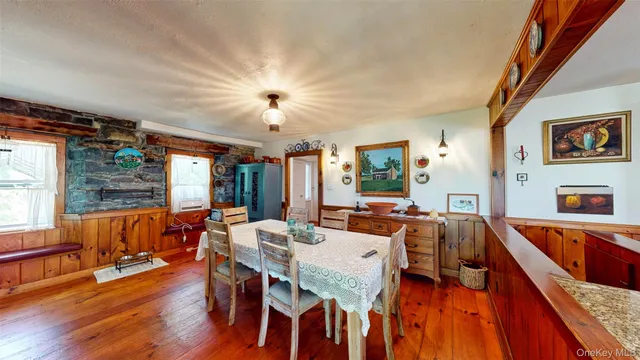 a view of a dining room with furniture window and wooden floor