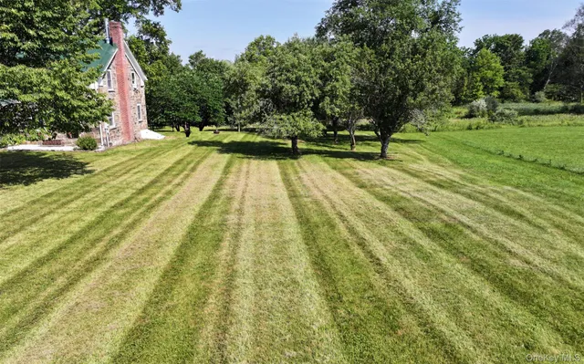 a view of a swimming pool with an outdoor seating and a yard