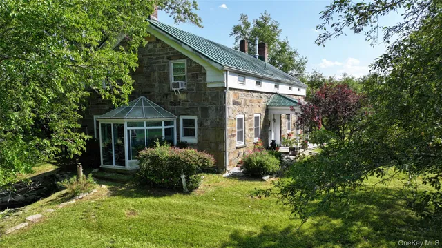 a front view of house with yard and green space