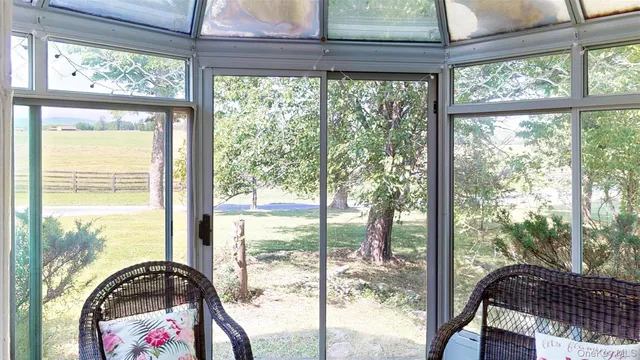 a room with a large window and a bed