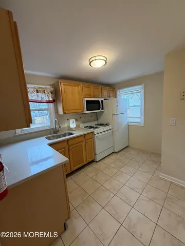 a kitchen with cabinets a sink and appliances