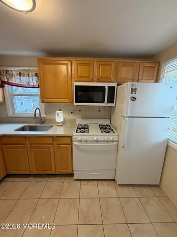 a kitchen with a sink a stove and a refrigerator