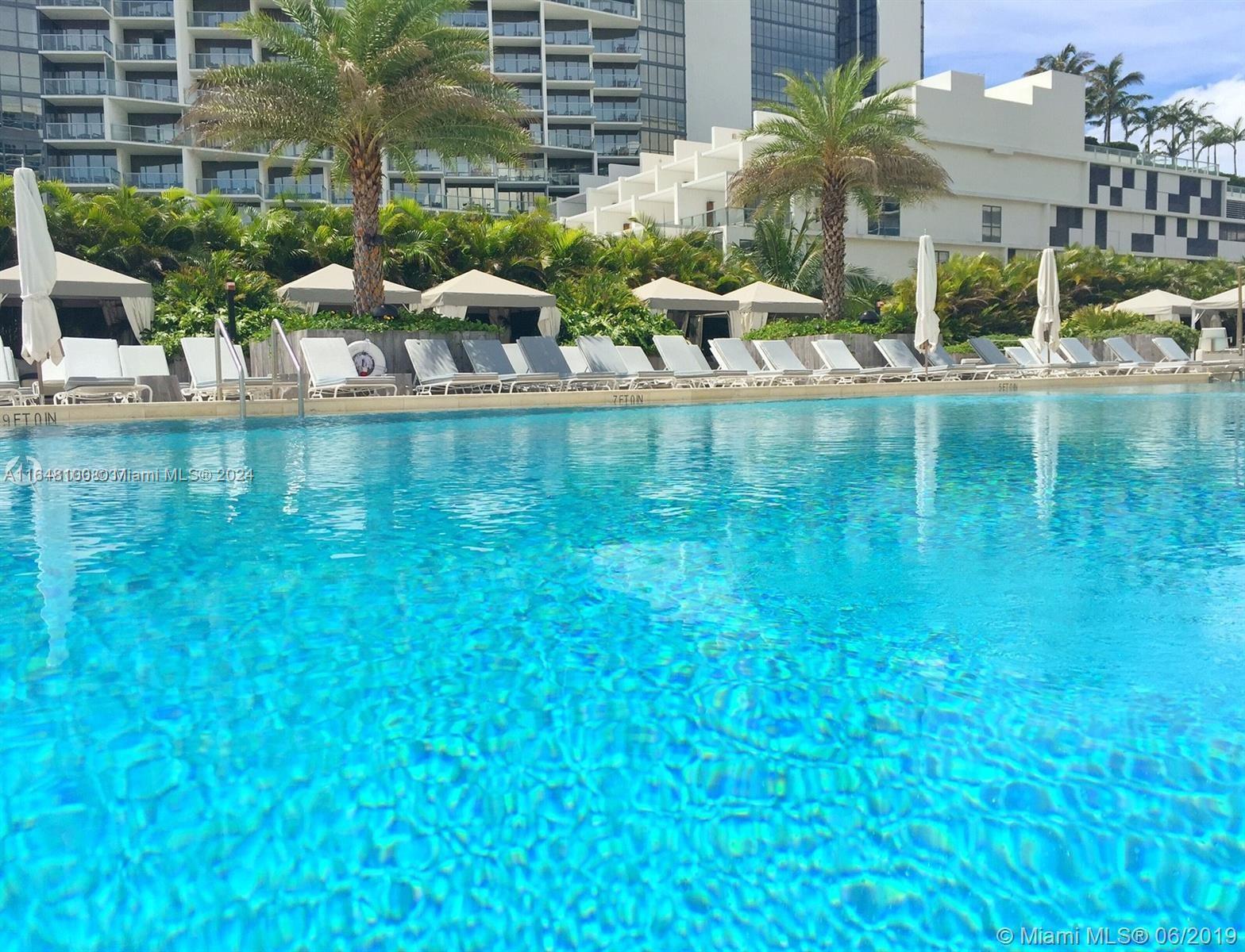 2301 Collins Avenue, Unit 617 Miami Beach, FL 33139 - Photo 6 of 8 a view of swimming pool with lawn chairs and plants