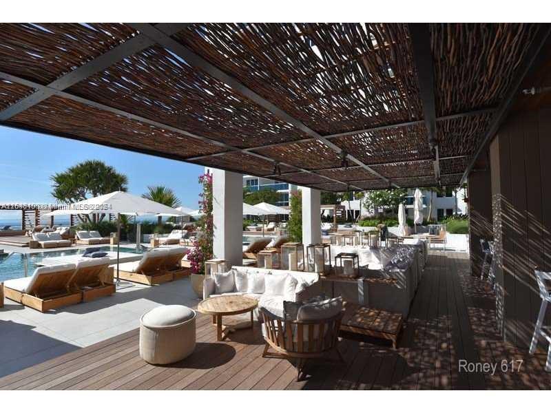2301 Collins Avenue, Unit 617 Miami Beach, FL 33139 - Photo 7 of 8 a view of a patio with couches and chairs