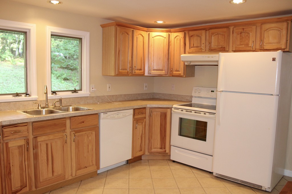 1663 Russell Road Montgomery, MA 01085 - Photo 2 of 17 a kitchen with a white cabinets and white appliances
