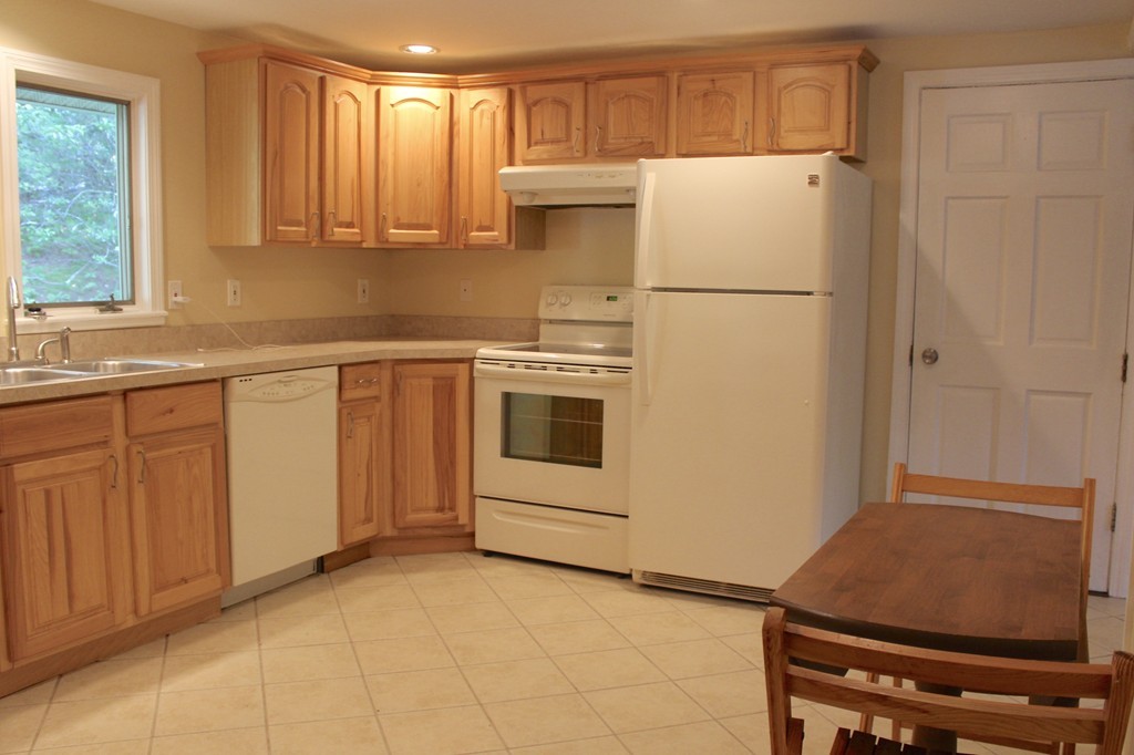 1663 Russell Road Montgomery, MA 01085 - Photo 3 of 17 a kitchen with stainless steel appliances a refrigerator sink and cabinets