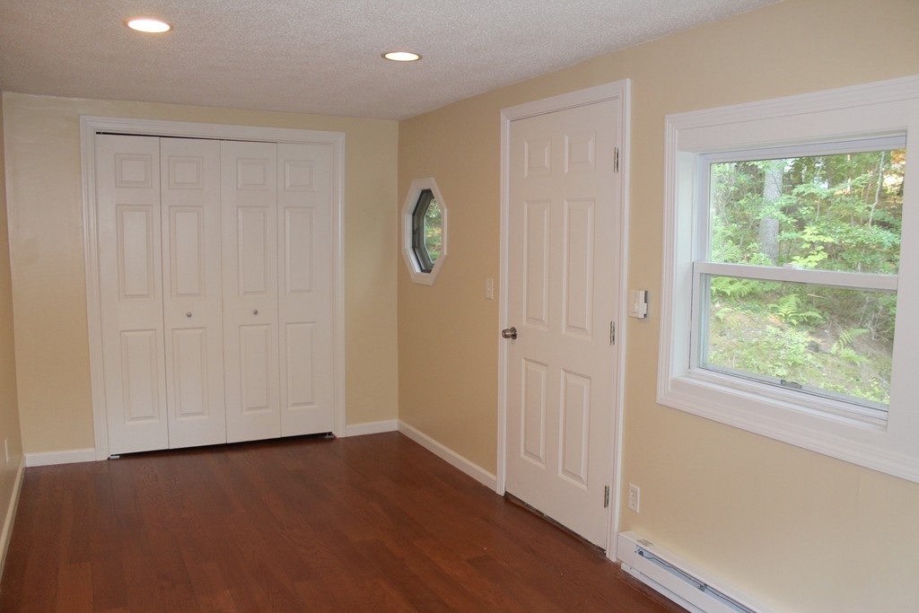 1663 Russell Road Montgomery, MA 01085 - Photo 10 of 17 an empty room with wooden floor and windows