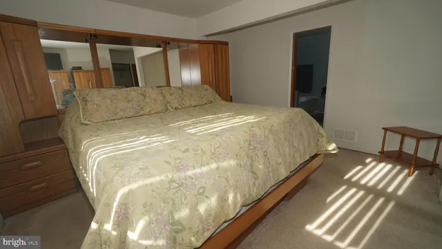 a bed sitting in a bedroom next to a window