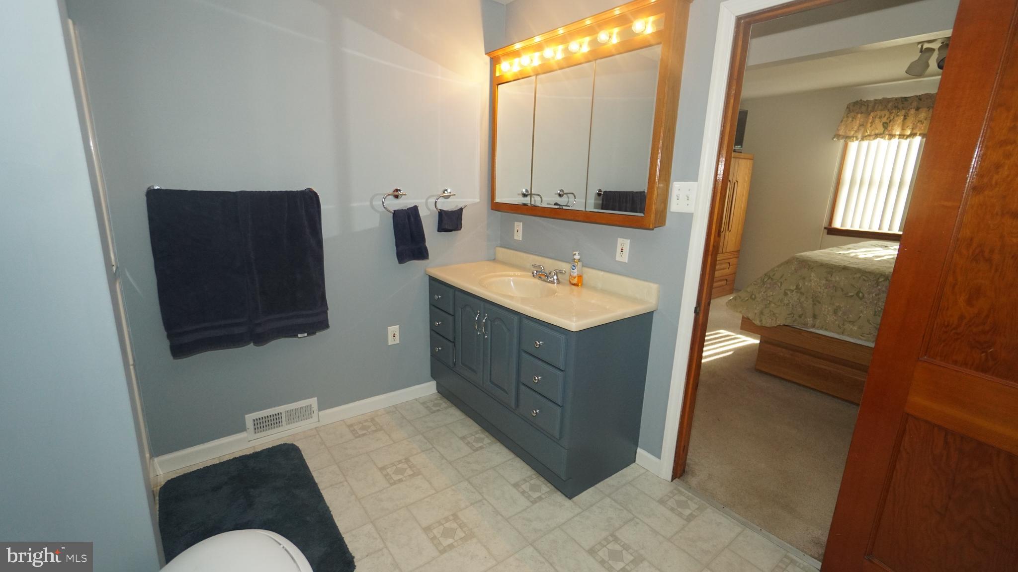 2307 State Rd. Croydon, PA 19021 - Photo 12 of 36 a spacious bathroom with a double vanity sink and a mirror