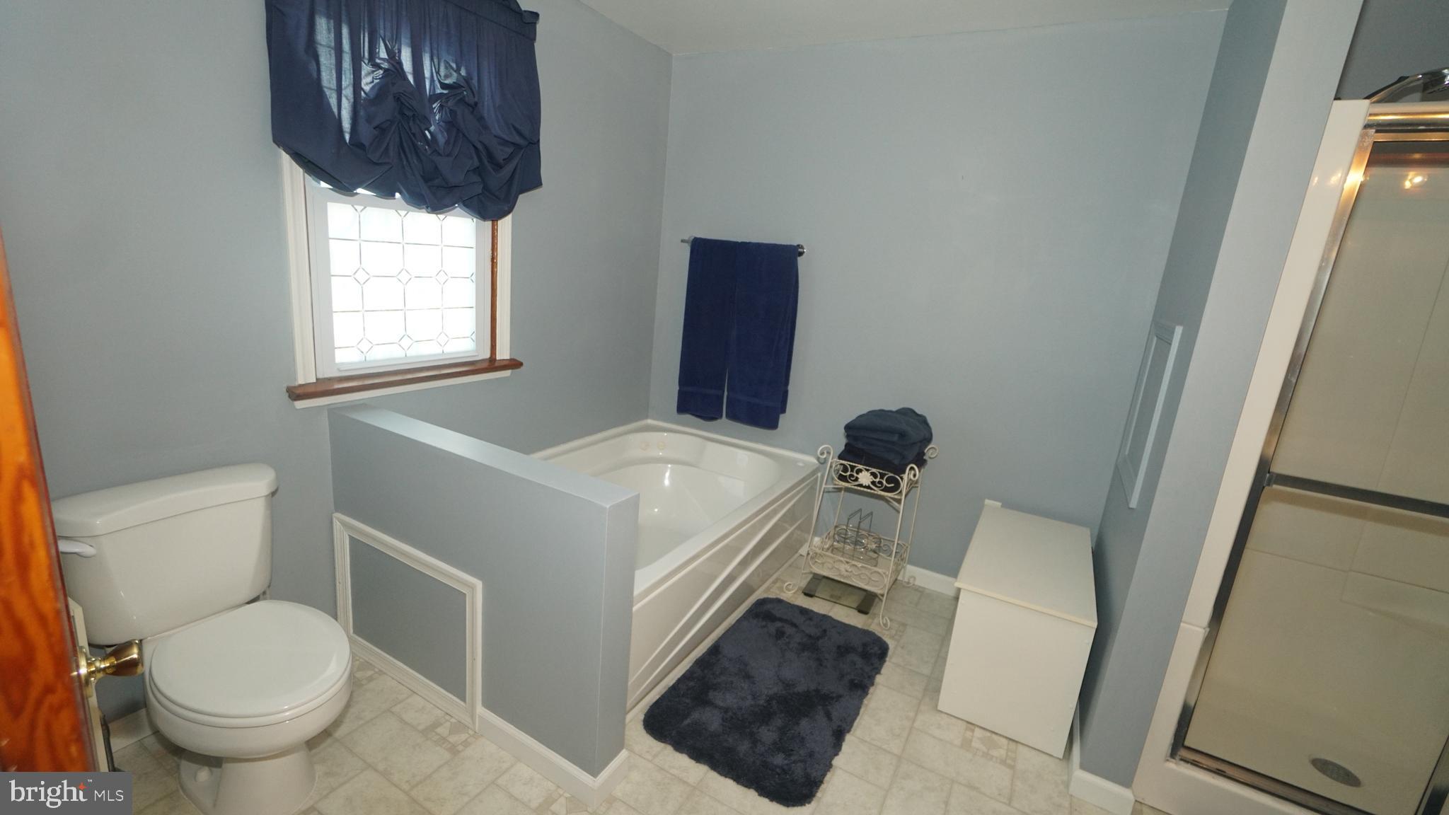 2307 State Rd. Croydon, PA 19021 - Photo 16 of 36 a bathroom with a toilet a sink and a window