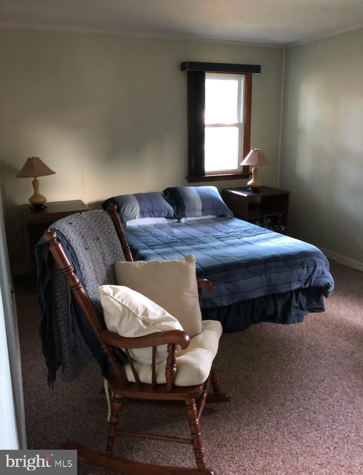 2307 State Rd. Croydon, PA 19021 - Photo 19 of 37 a bedroom with a bed table chair and window